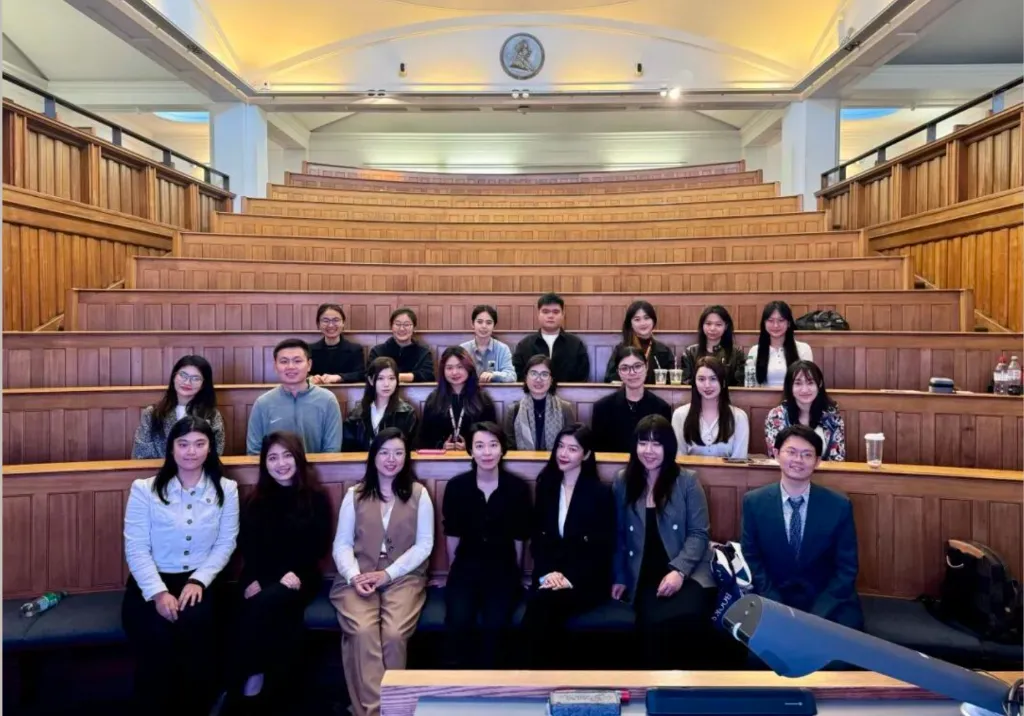 Alumni group photo in a UCL lecture theatre
